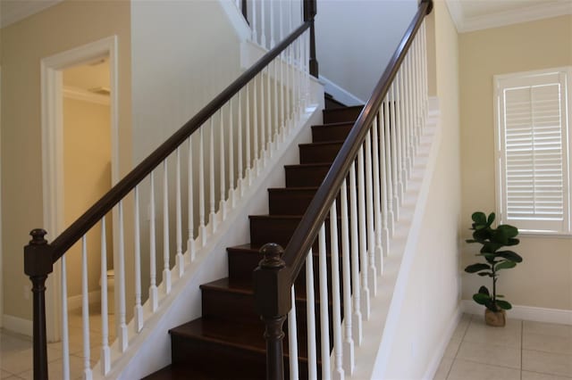 staircase featuring tile patterned flooring and crown molding