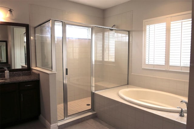 bathroom with tile patterned flooring, vanity, and independent shower and bath