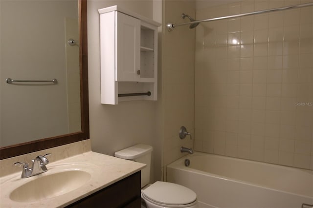 full bathroom featuring vanity, tiled shower / bath combo, and toilet