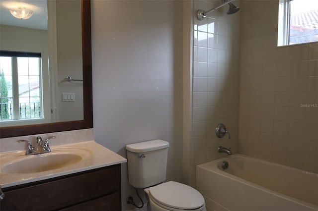 full bathroom with vanity, toilet, and tiled shower / bath