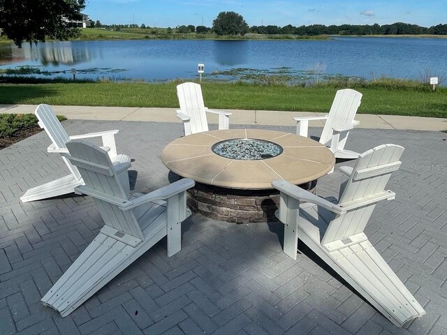 view of patio / terrace with a water view and an outdoor fire pit