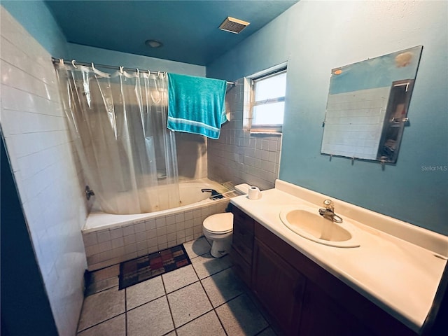 full bathroom with tile patterned floors, vanity, shower / tub combo, and toilet