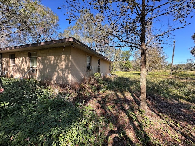 view of home's exterior with concrete block siding