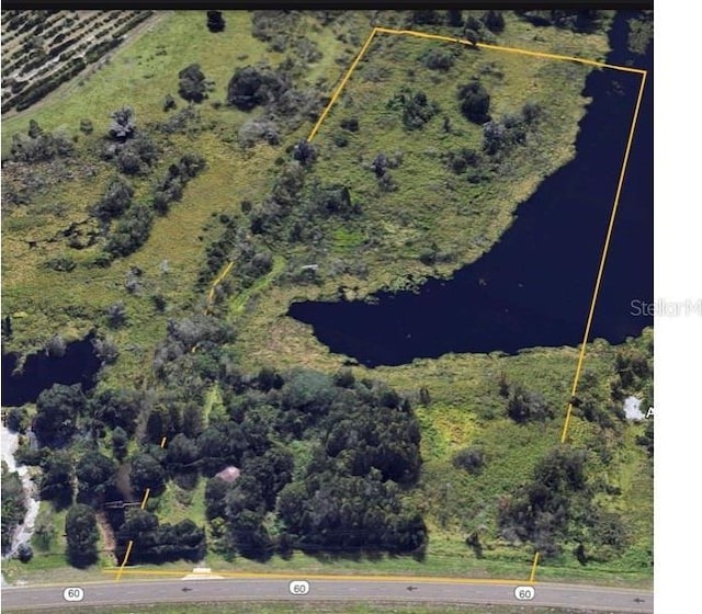 aerial view of property's location featuring property parcel outlined and a large body of water