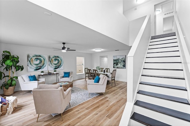 living room with ceiling fan and light hardwood / wood-style floors