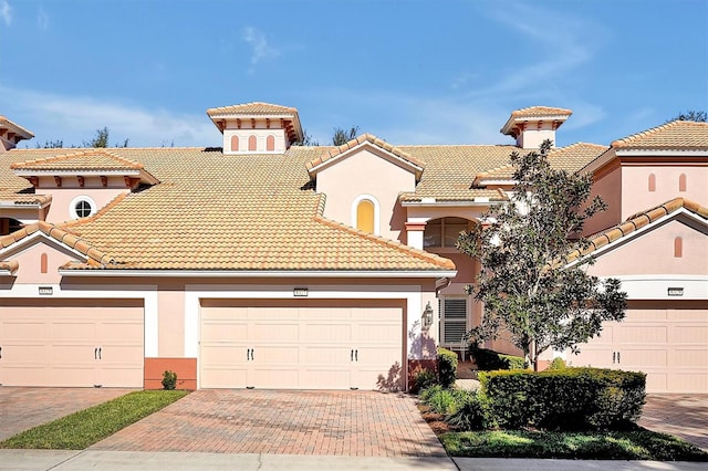 mediterranean / spanish house featuring a garage