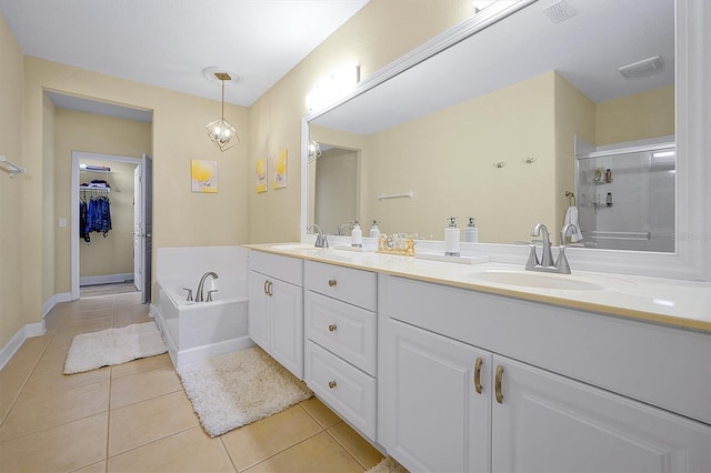 bathroom with tile patterned floors, separate shower and tub, and vanity