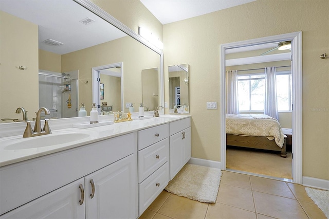 bathroom with tile patterned flooring, vanity, and a shower with shower door