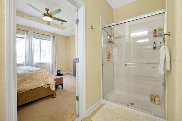 bathroom featuring ceiling fan and an enclosed shower