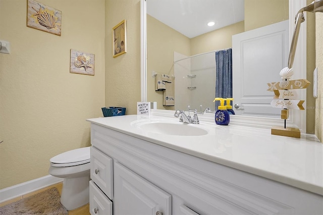 bathroom featuring tile patterned flooring, vanity, curtained shower, and toilet