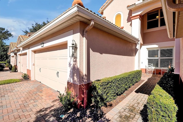 view of side of property with a garage