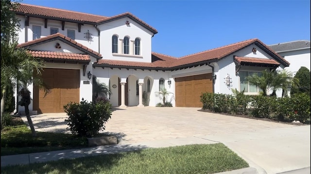 mediterranean / spanish-style house with a garage