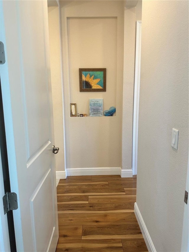 corridor featuring dark hardwood / wood-style floors