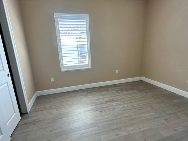 unfurnished room with light wood-type flooring