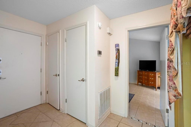 hallway featuring light tile patterned floors