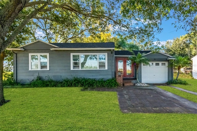 ranch-style home with a front lawn and a garage