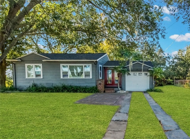 ranch-style house with a garage and a front lawn