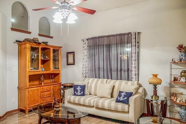 living room featuring ceiling fan and light wood-type flooring