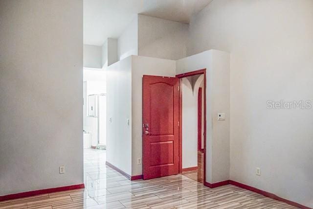 unfurnished room featuring a towering ceiling