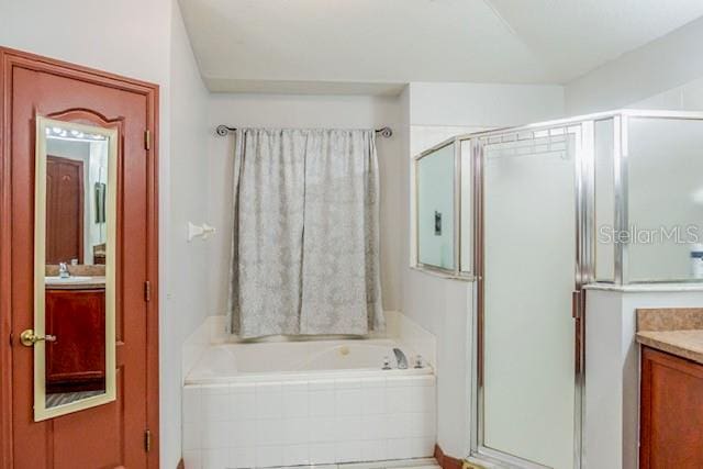 bathroom featuring vanity and plus walk in shower