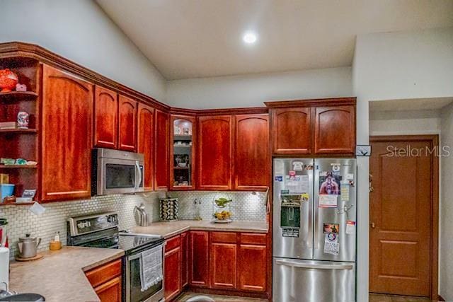 kitchen featuring appliances with stainless steel finishes and decorative backsplash