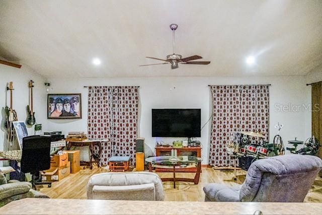 living room with ceiling fan and hardwood / wood-style floors