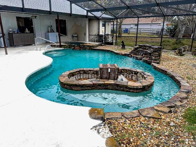 view of swimming pool with a lanai, a patio, and an in ground hot tub