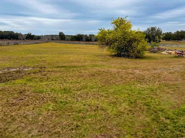 view of yard with a rural view