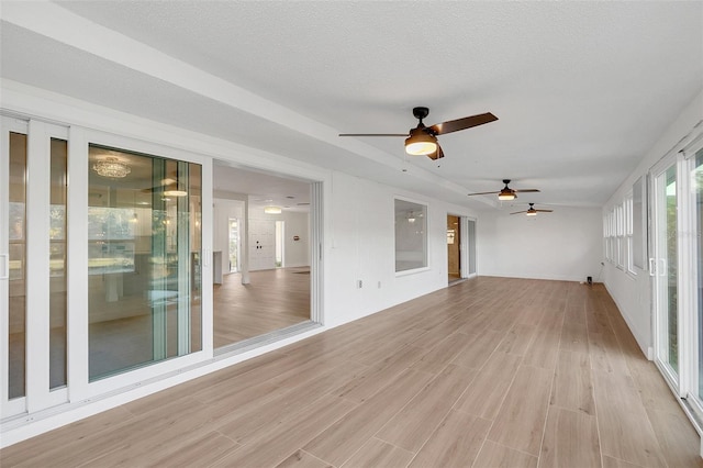 interior space with ceiling fan