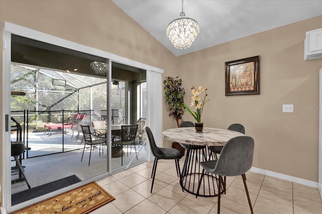 dining room with a notable chandelier, light tile patterned flooring, and lofted ceiling