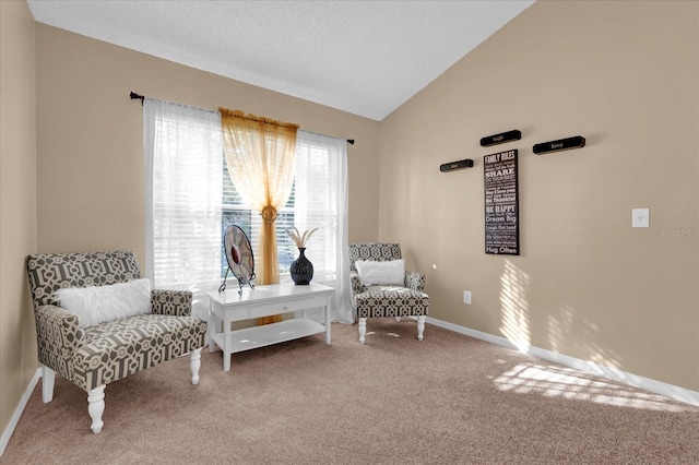 living area featuring carpet floors and lofted ceiling