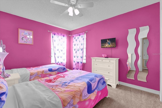 carpeted bedroom featuring a textured ceiling and ceiling fan