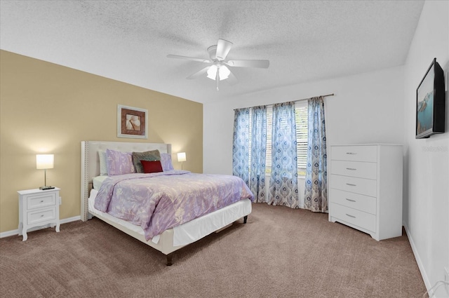 carpeted bedroom with a textured ceiling and ceiling fan