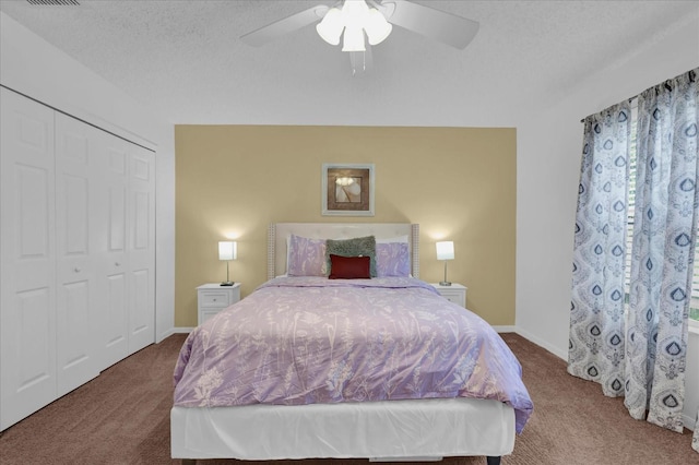 carpeted bedroom with a textured ceiling, a closet, and ceiling fan