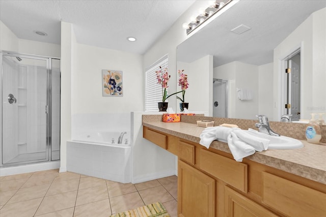 bathroom featuring tile patterned flooring, vanity, independent shower and bath, and a textured ceiling