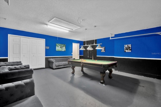 recreation room with concrete flooring, a textured ceiling, and billiards