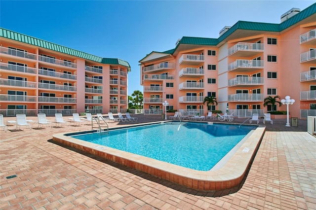 view of swimming pool featuring a patio area