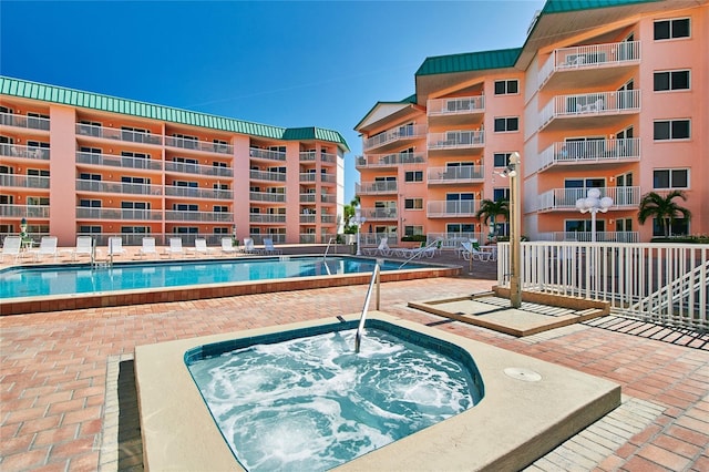 view of pool with a community hot tub