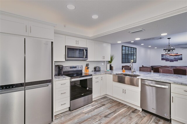 18400 Gulf Blvd Unit 1206, Indian Shores, FL 33785 - kitchen featuring appliances with stainless steel finishes, white cabinetry, light stone countertops, and recessed lighting