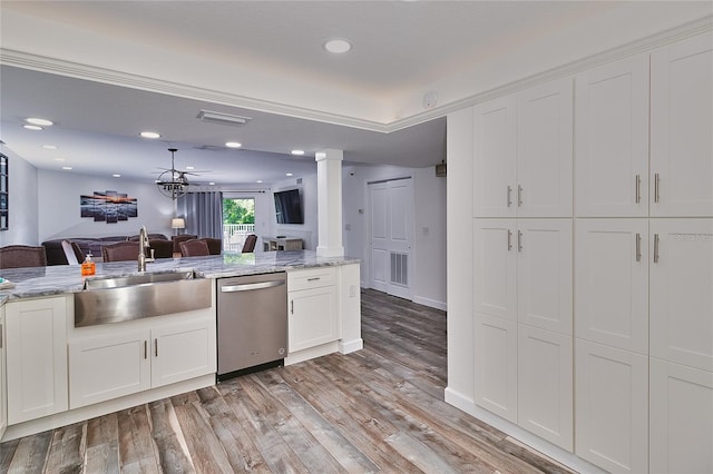 18400 Gulf Blvd Unit 1206, Indian Shores, FL 33785 - kitchen featuring stainless steel dishwasher, open floor plan, white cabinetry, ornate columns, and light wood finished floors