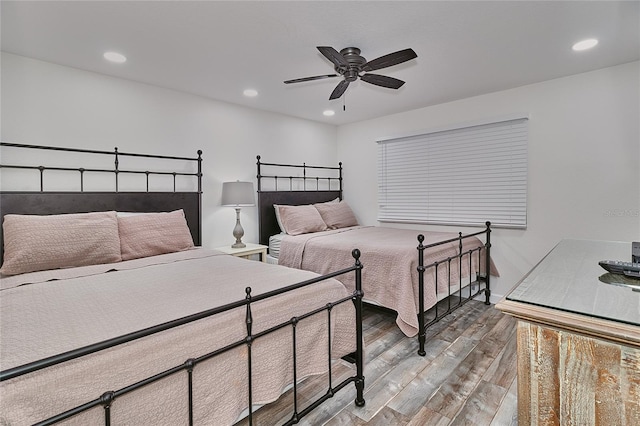 bedroom with hardwood / wood-style flooring and ceiling fan