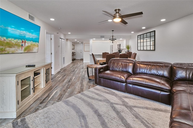 living room with ceiling fan and hardwood / wood-style floors