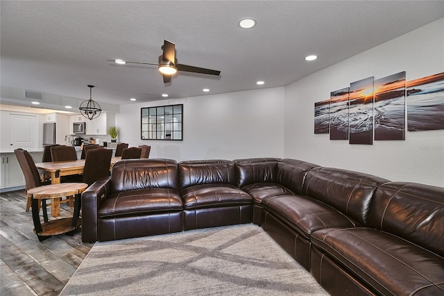 18400 Gulf Blvd Unit 1206, Indian Shores, FL 33785 - living room with wood finished floors, recessed lighting, a ceiling fan, a chandelier, and a textured ceiling