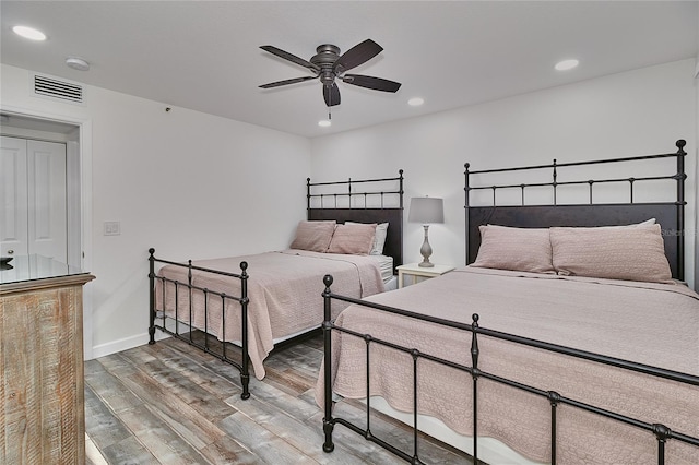 bedroom with hardwood / wood-style floors and ceiling fan