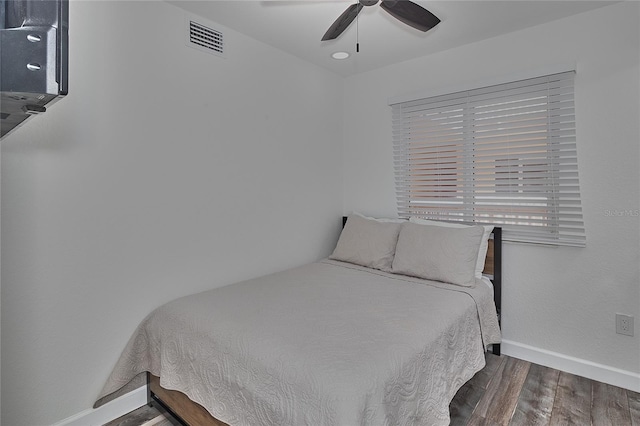 bedroom featuring ceiling fan and dark hardwood / wood-style flooring