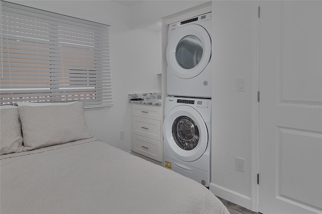 18400 Gulf Blvd Unit 1206, Indian Shores, FL 33785 - bedroom featuring stacked washer / drying machine and wood finished floors