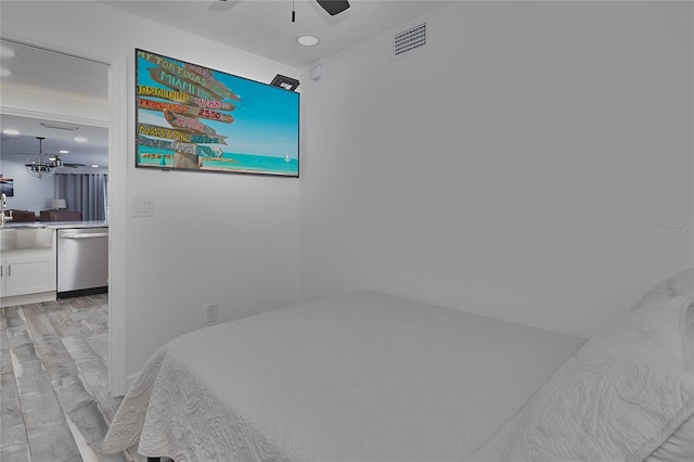 bedroom featuring ceiling fan, light hardwood / wood-style floors, and sink