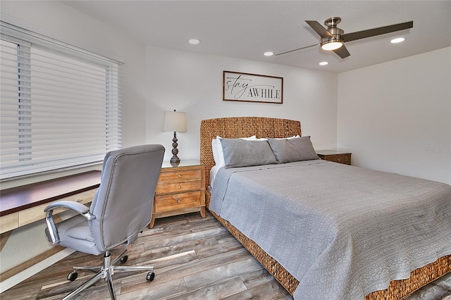 bedroom with ceiling fan and hardwood / wood-style flooring