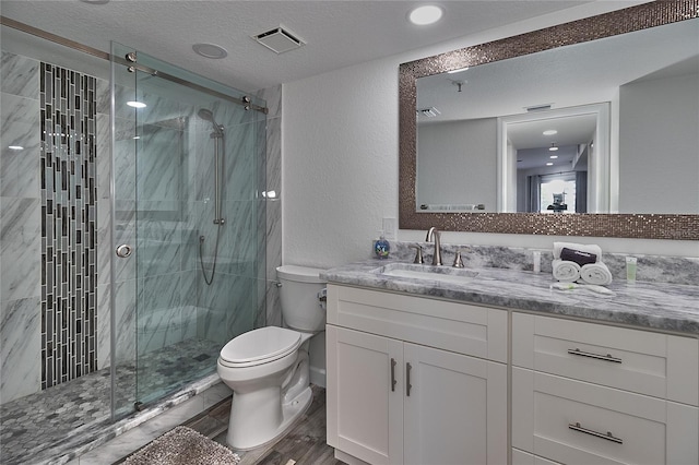 18400 Gulf Blvd Unit 1206, Indian Shores, FL 33785 - full bath featuring vanity, a stall shower, wood finished floors, a textured wall, and a textured ceiling
