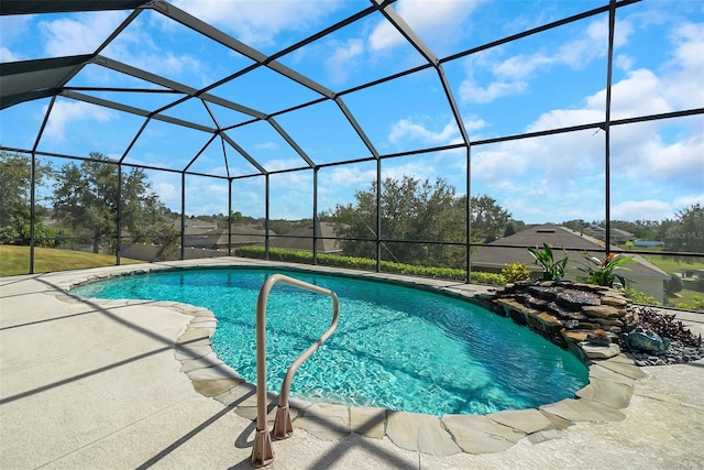 view of pool featuring glass enclosure and a patio